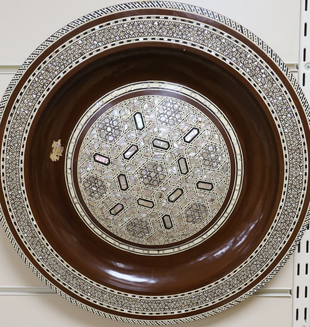 A circular polished wood wall plate with micro mosaic inlays in mother of pearl, Moroccan style, 41cm
